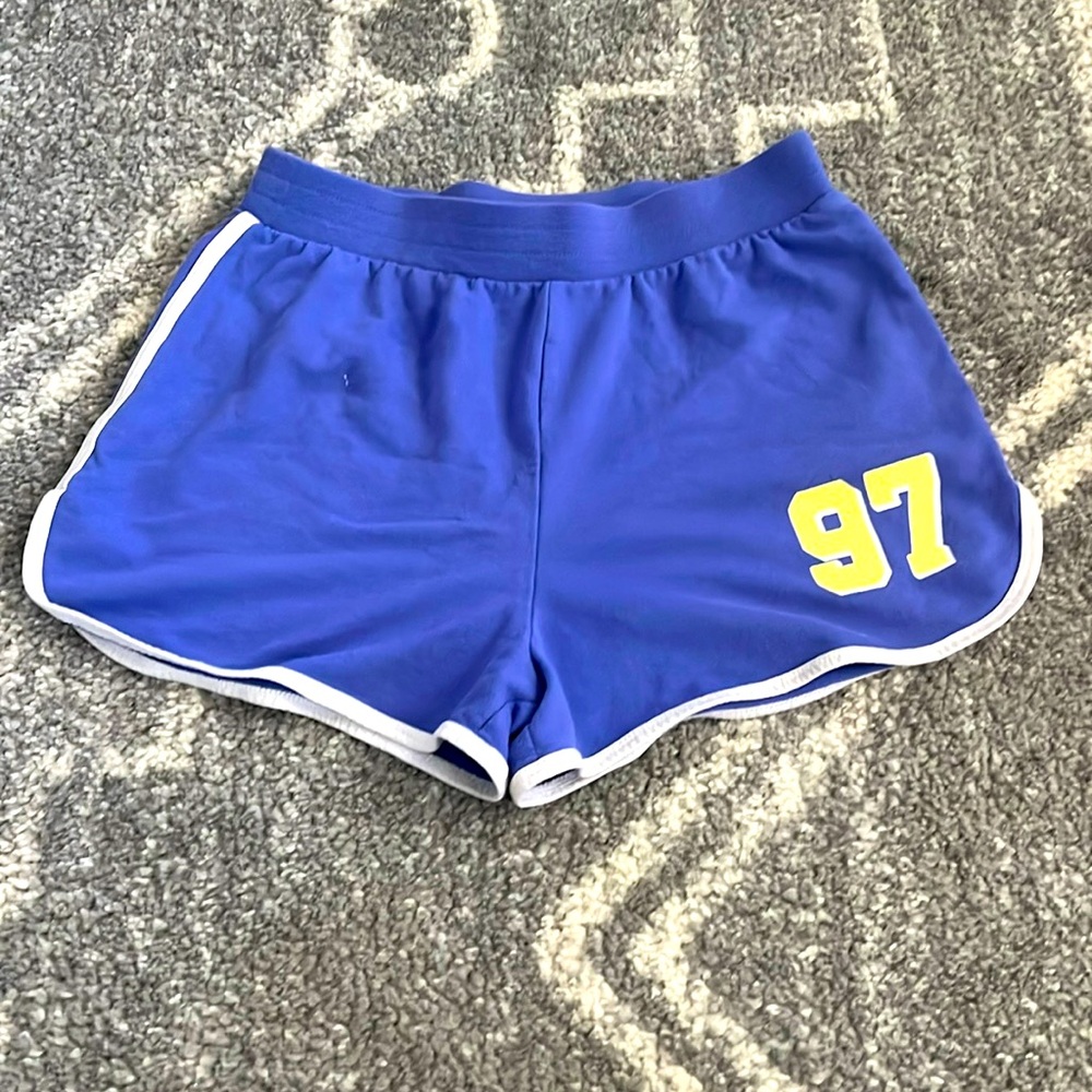 Selling a purple and white pair of No Boundaries running shorts.